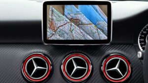 Close-up of a luxury car dashboard featuring a GPS navigation system displaying a road map.